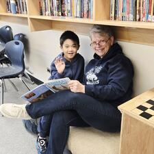Literacy event- teacher reading with a student from another class