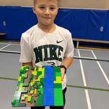 Students working on a Lego challenge presented by Brick Connections